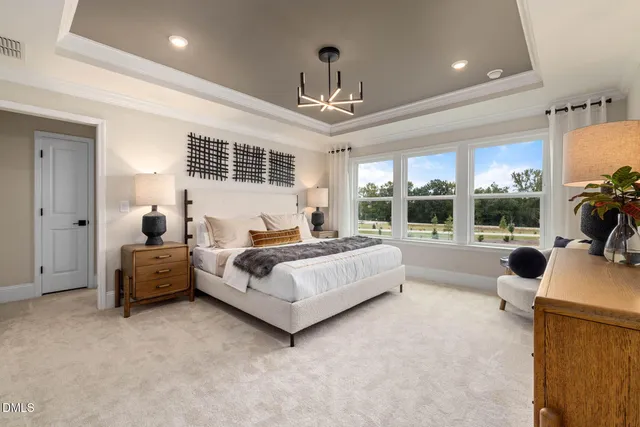 a spacious bedroom with a bed and a couch