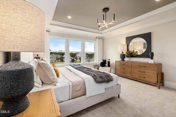 a spacious bedroom with a bed and a large window