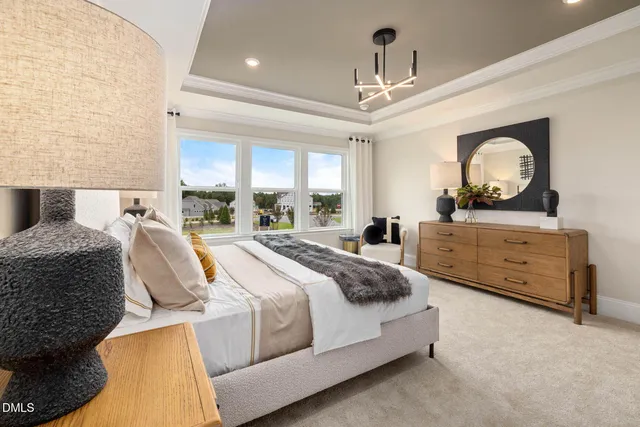 a spacious bedroom with a bed and a large window