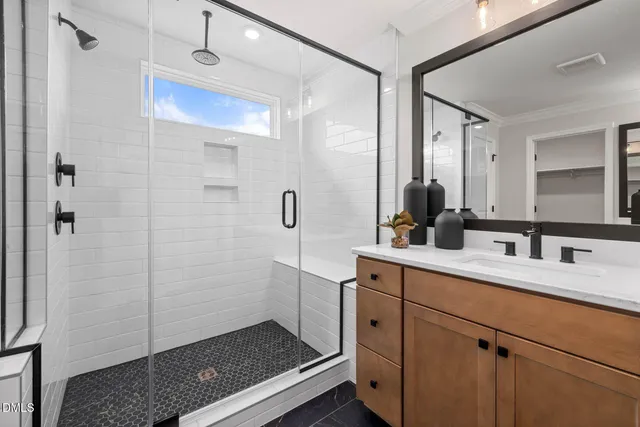 a spacious bathroom with a shower sink and mirror
