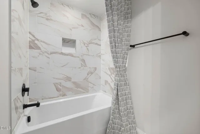 a bedroom with two beds and a large window