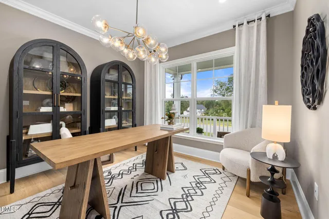 a dining room with furniture a rug and wooden floor