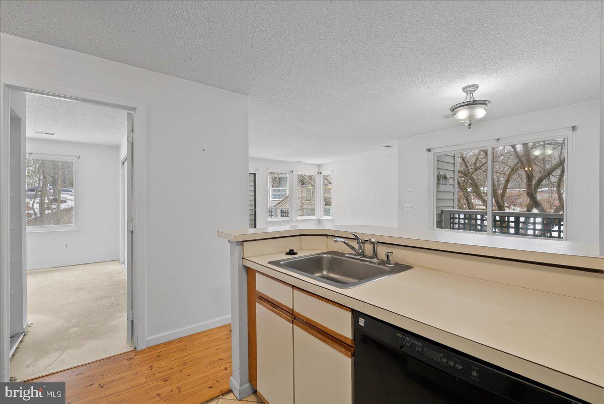 11719 Summerchase Circle Reston, VA 20194 - Photo 12 of 25 a kitchen that has a sink and a stove with wooden floor