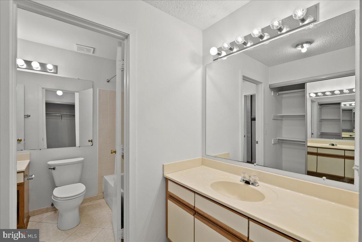 11719 Summerchase Circle Reston, VA 20194 - Photo 20 of 25 a bathroom with a sink a toilet and shower