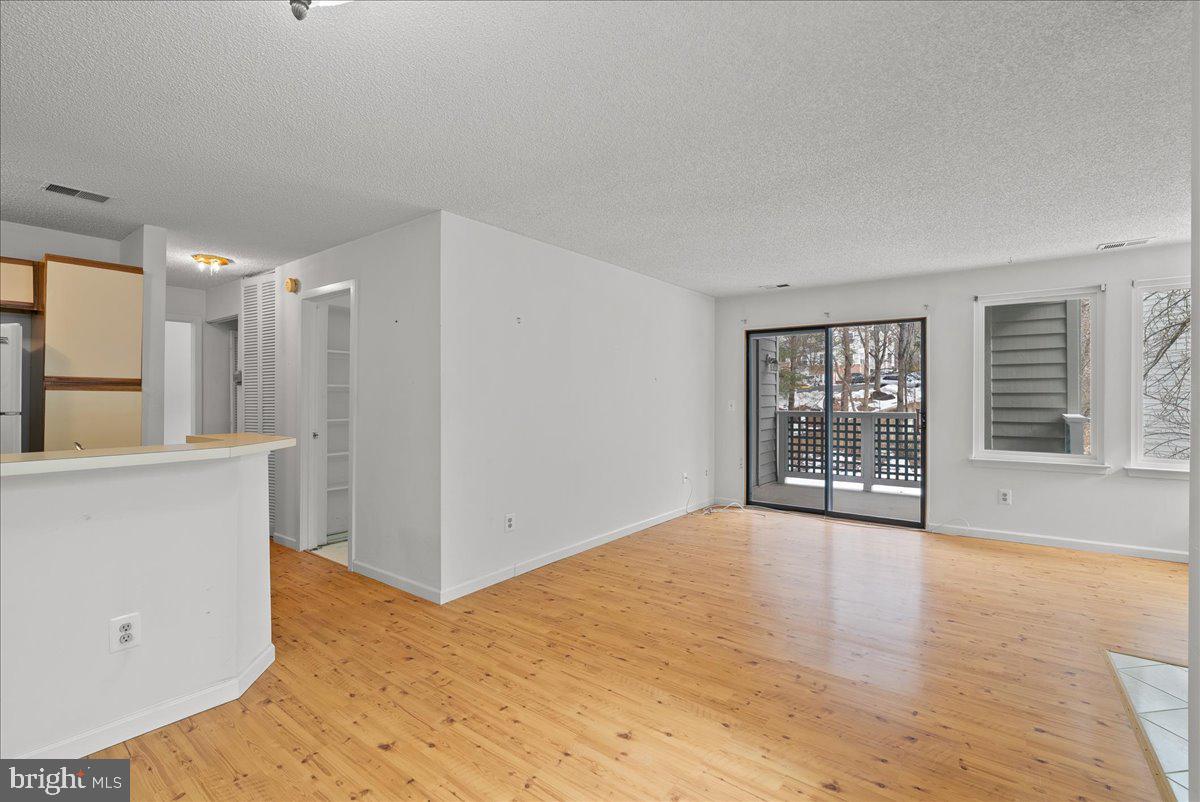 11719 Summerchase Circle Reston, VA 20194 - Photo 8 of 25 a view of an empty room with a window and wooden floor