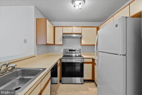 a kitchen that has a sink and a stove