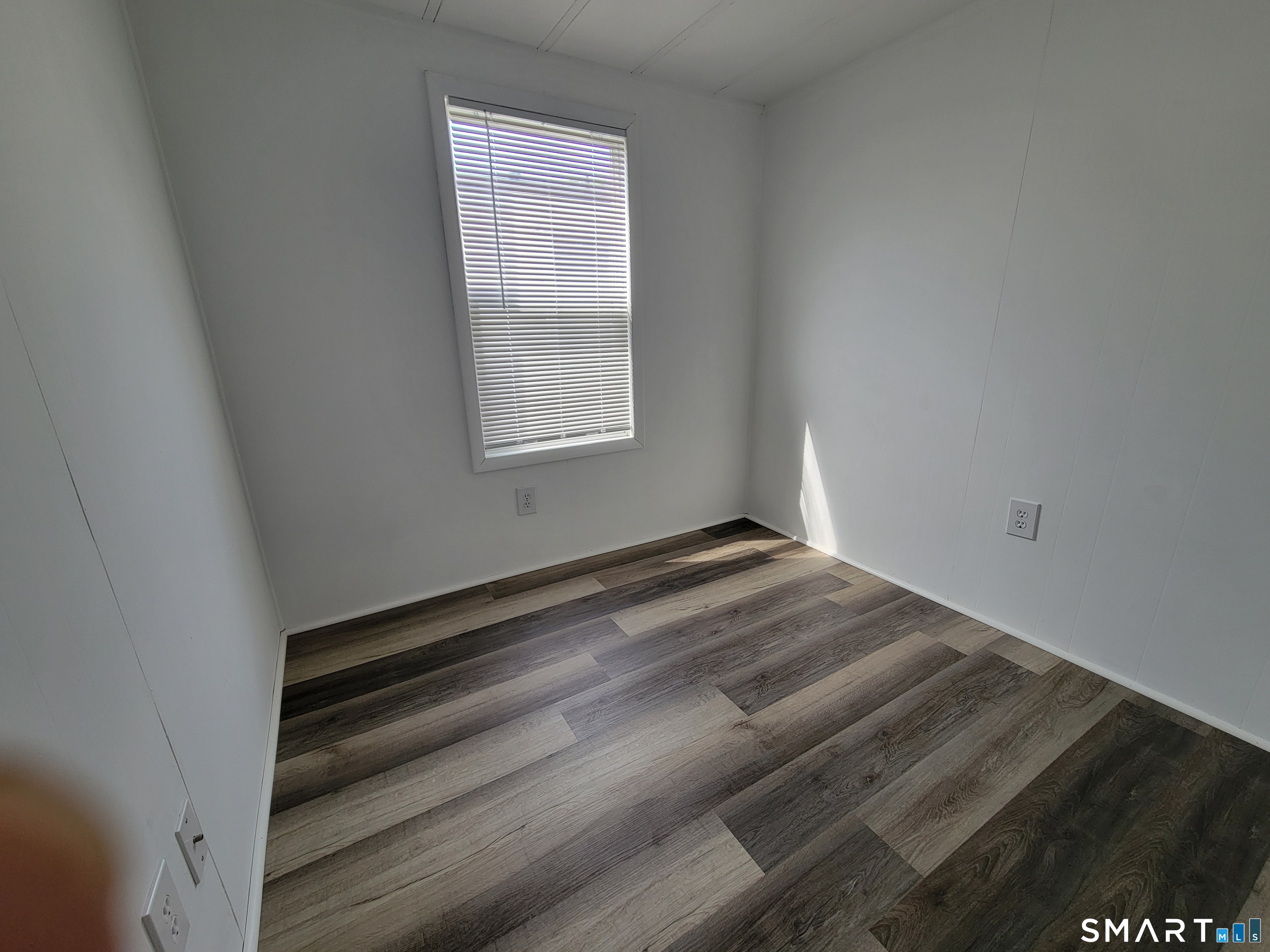 1290 N Road Groton, CT 06340 - Photo 8 of 11 a view of empty room with wooden floor and fan
