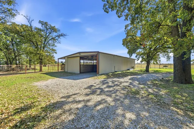 a living room with furniture kitchen view and a large window