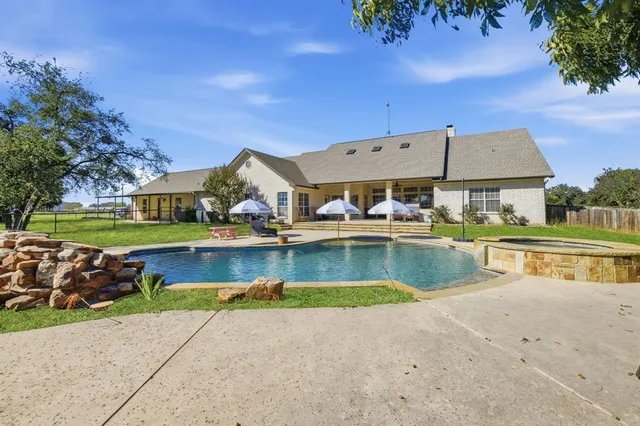 an aerial view of a house with swimming pool