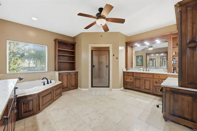 a large bathroom with a large tub sink shower and mirror