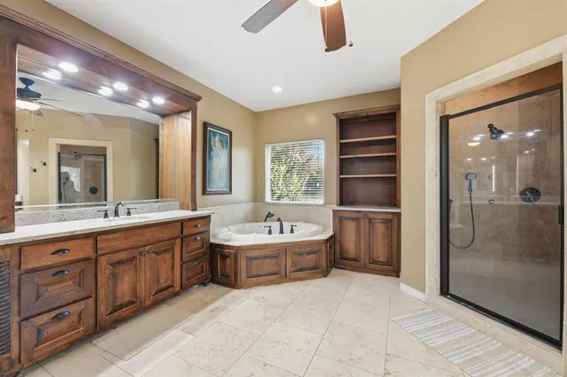 a large bathroom with a large tub shower and sink