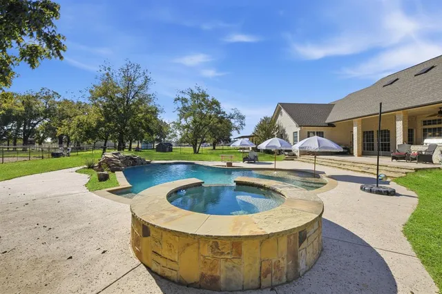 a view of a swimming pool with a patio