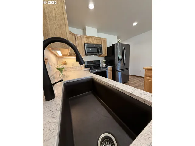 a kitchen with a refrigerator sink and microwave
