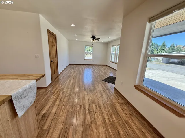 a view of kitchen with granite countertop cabinets and refrigerator