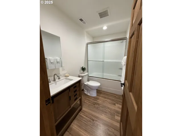 a bathroom with a sink a mirror and vanity