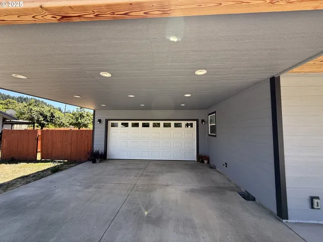 a large kitchen with stainless steel appliances granite countertop a stove a sink dishwasher and a microwave oven with wooden floor