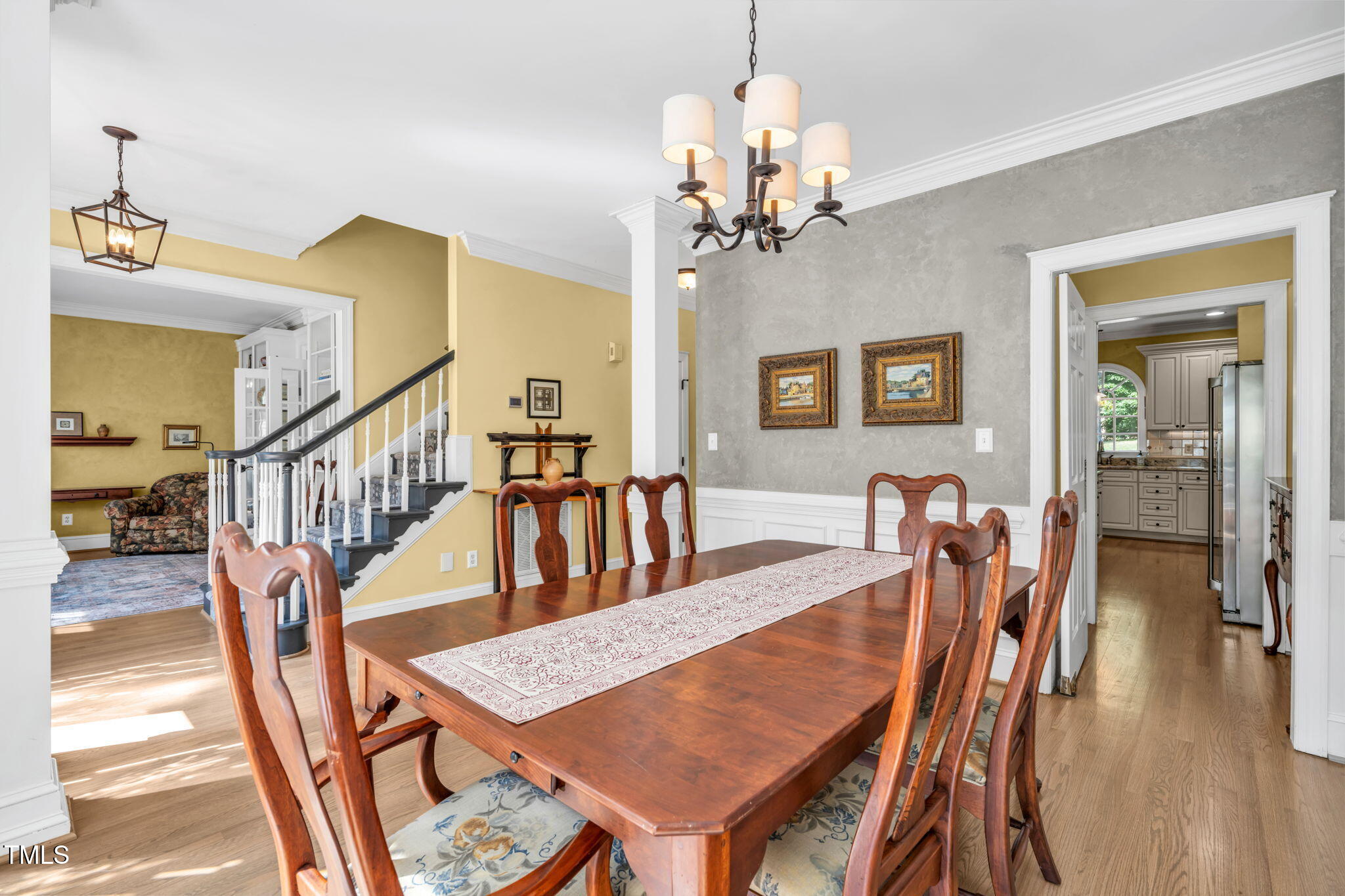 9009 Hometown Drive Raleigh, NC 27615 - Photo 12 of 82 a dining room with furniture a chandelier and wooden floor