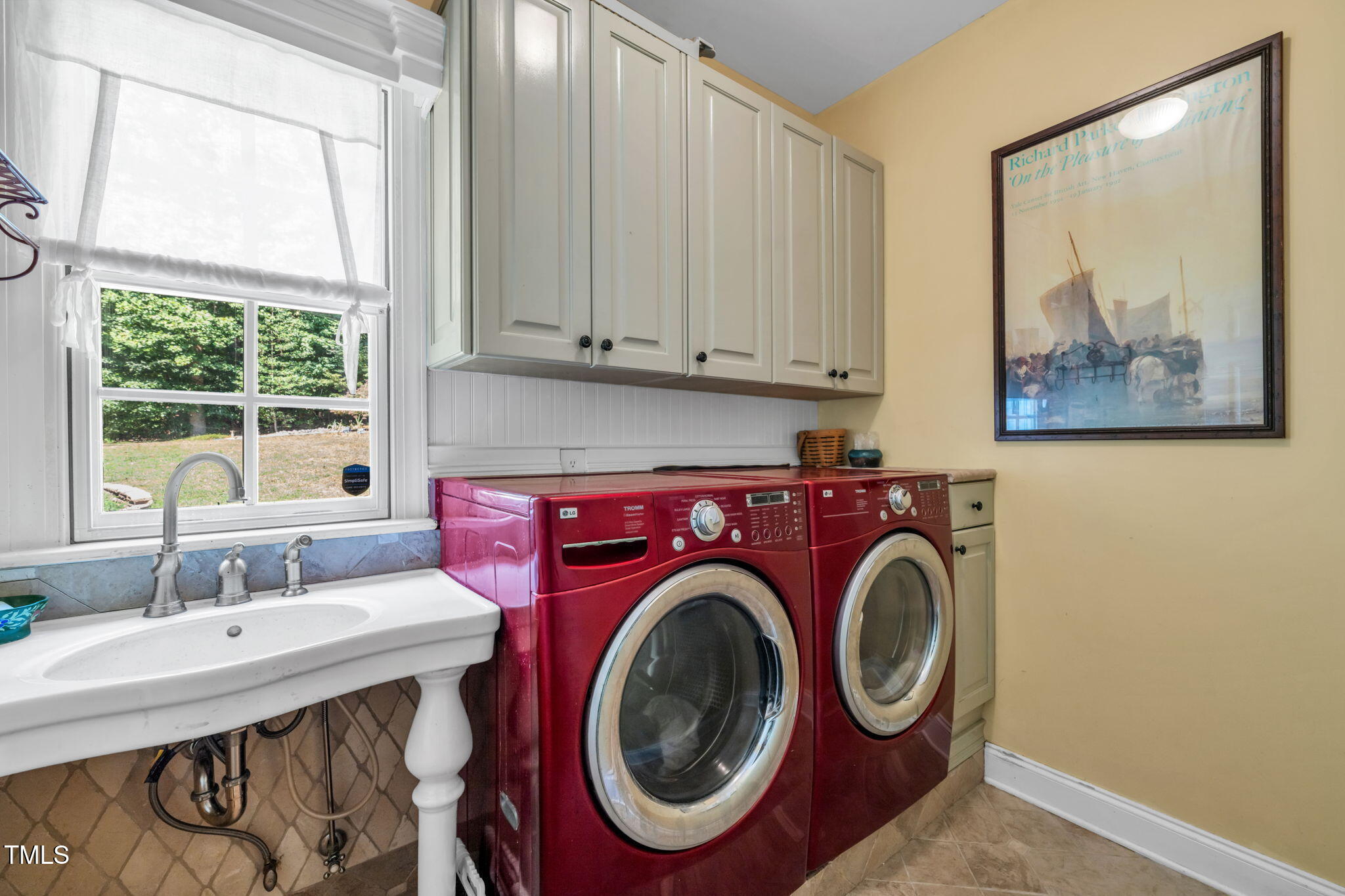 9009 Hometown Drive Raleigh, NC 27615 - Photo 26 of 82 a bathroom with a sink a toilet and a large mirror next to a window