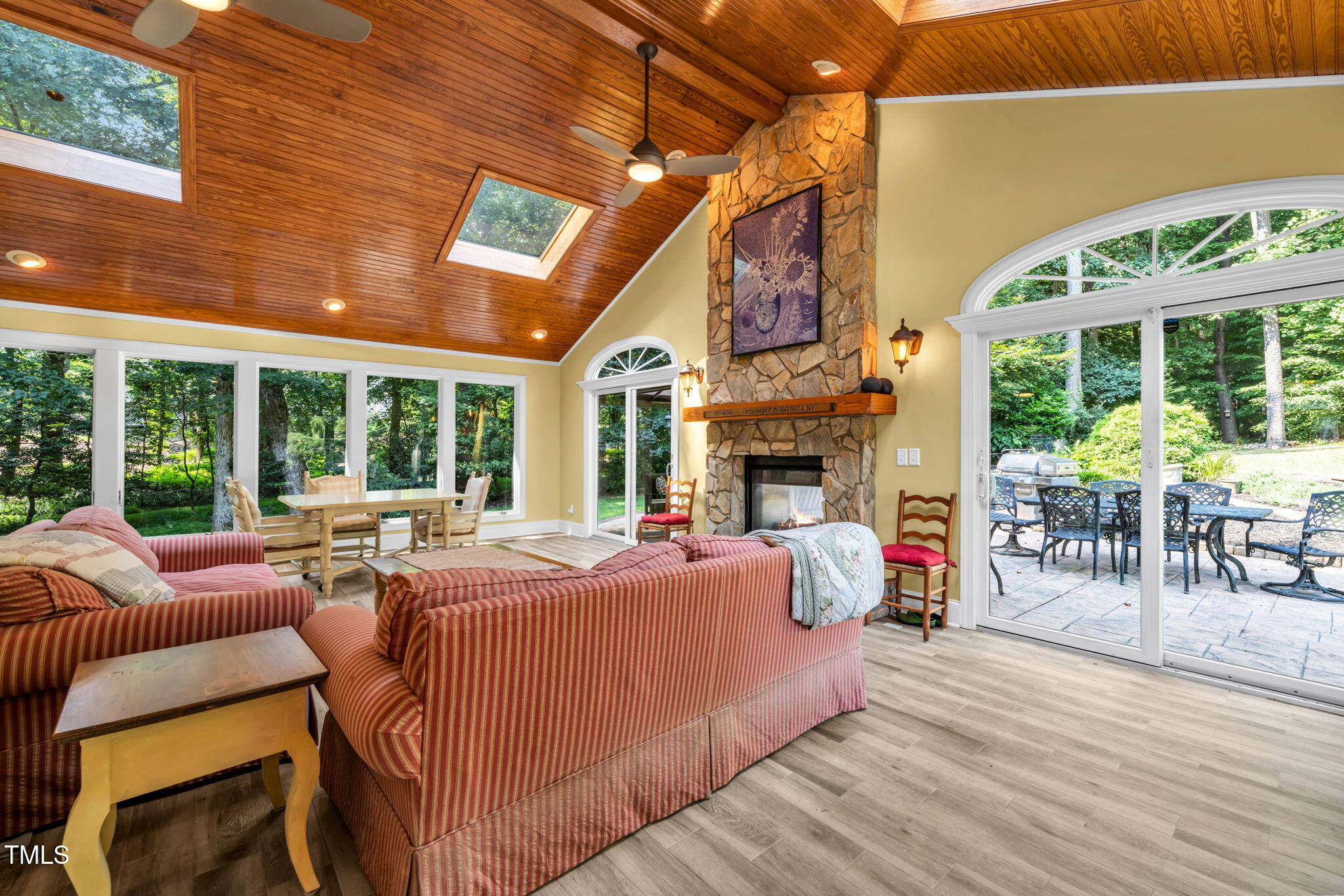 9009 Hometown Drive Raleigh, NC 27615 - Photo 27 of 82 a living room with furniture a fireplace and floor to ceiling window
