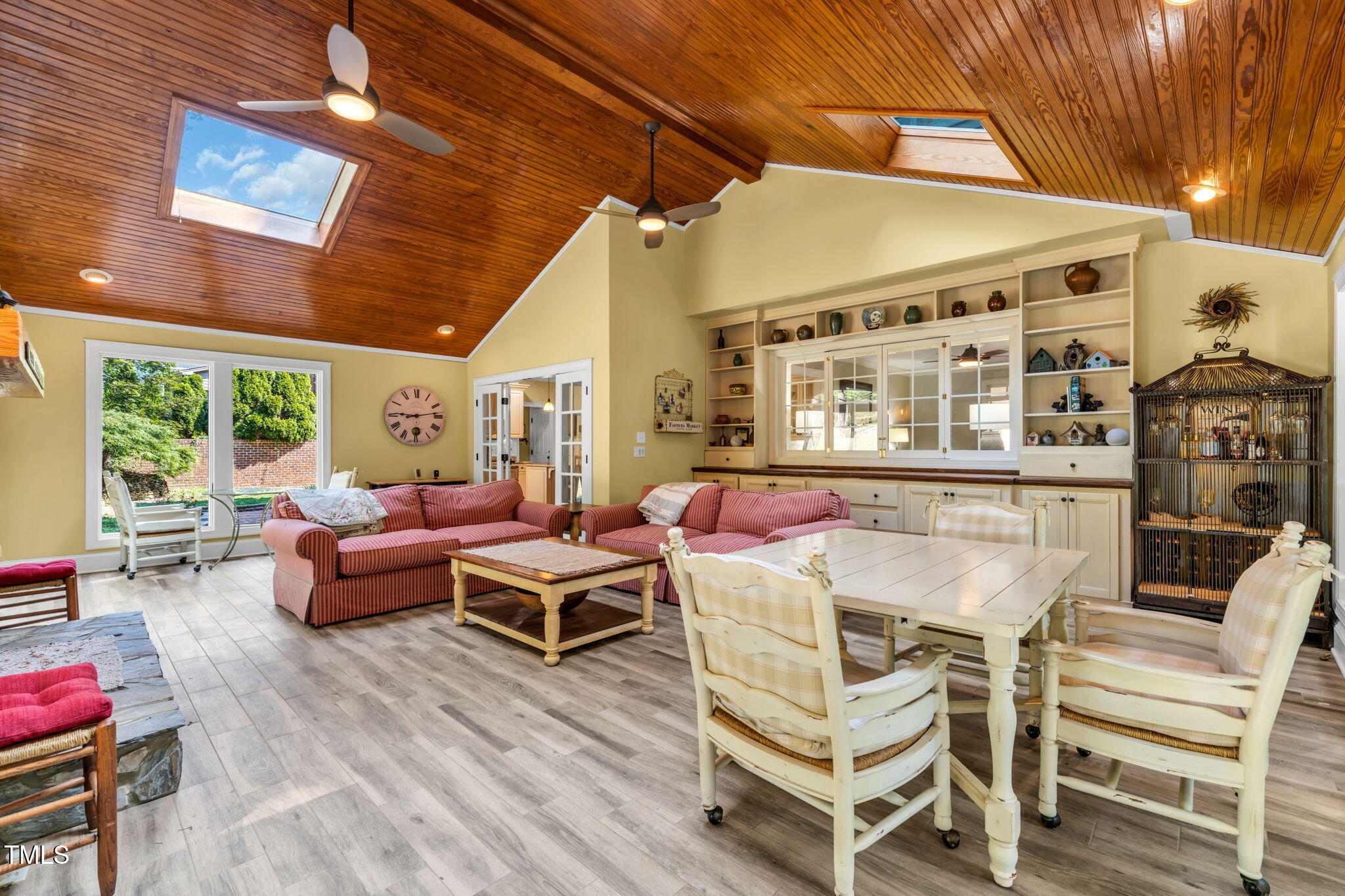 9009 Hometown Drive Raleigh, NC 27615 - Photo 29 of 82 a view of a patio with dining table and chairs with wooden floor and fence