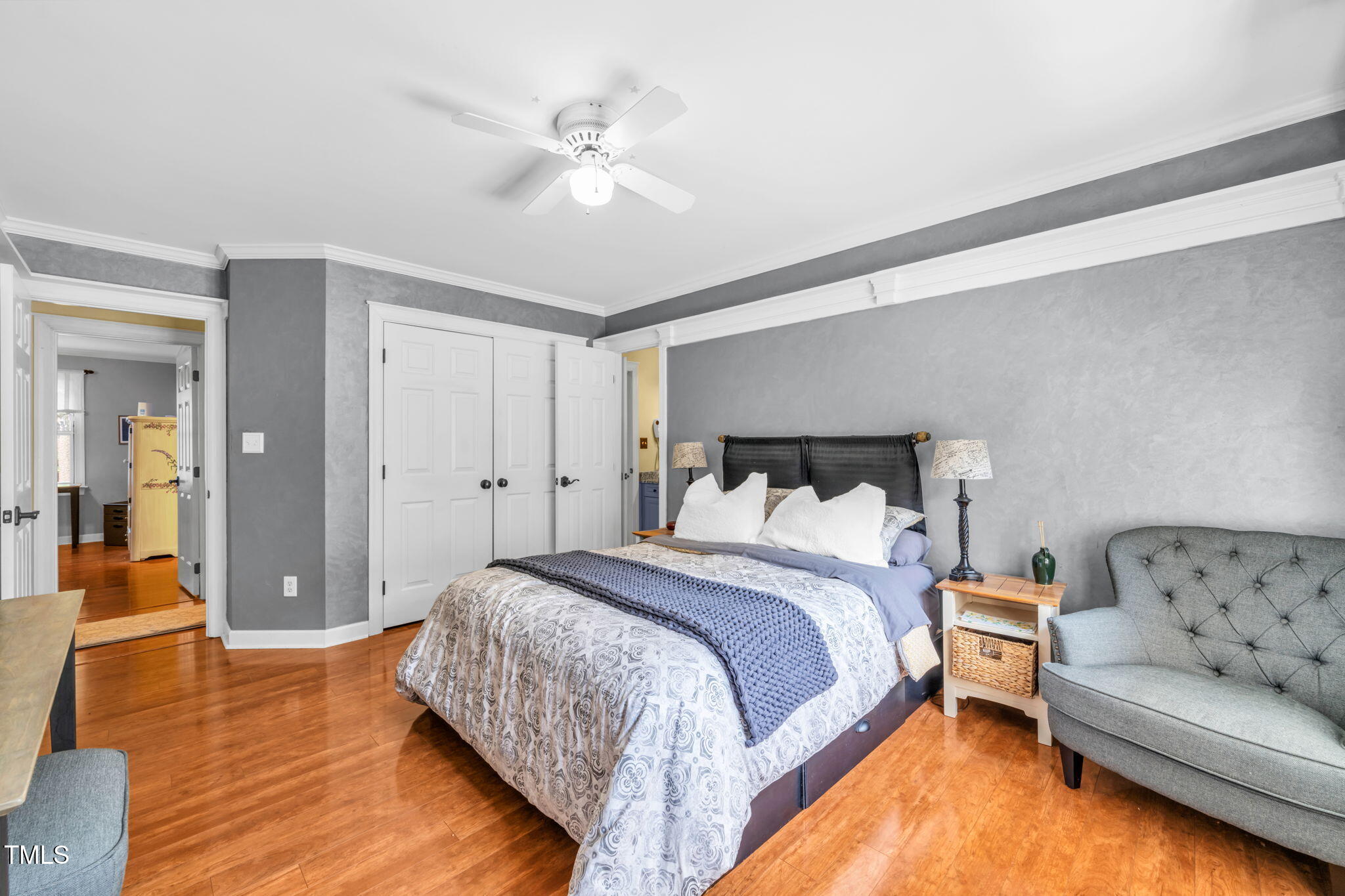 9009 Hometown Drive Raleigh, NC 27615 - Photo 38 of 82 a spacious bedroom with a bed and a couch