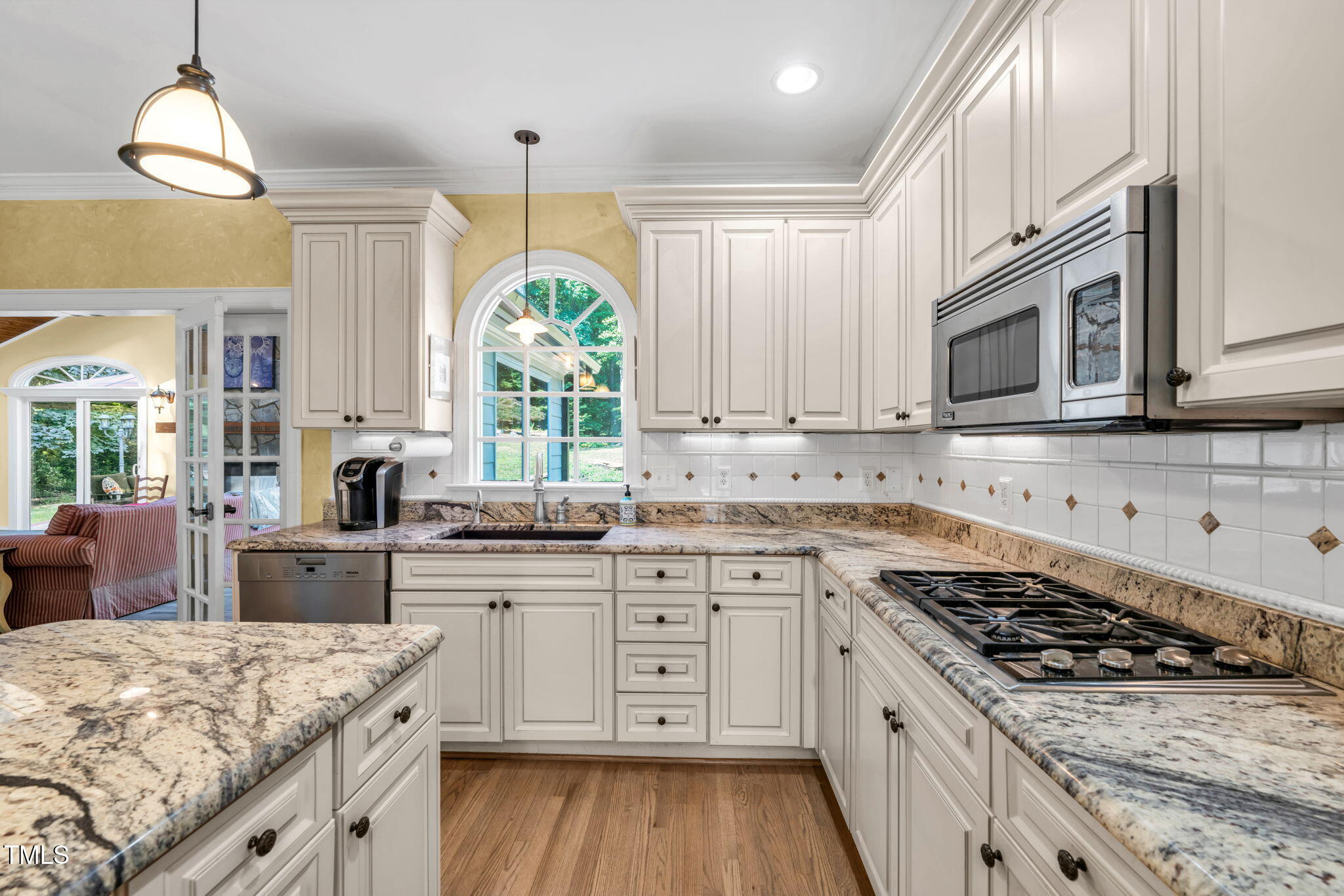 9009 Hometown Drive Raleigh, NC 27615 - Photo 3 of 82 a kitchen with a stove a sink and a microwave