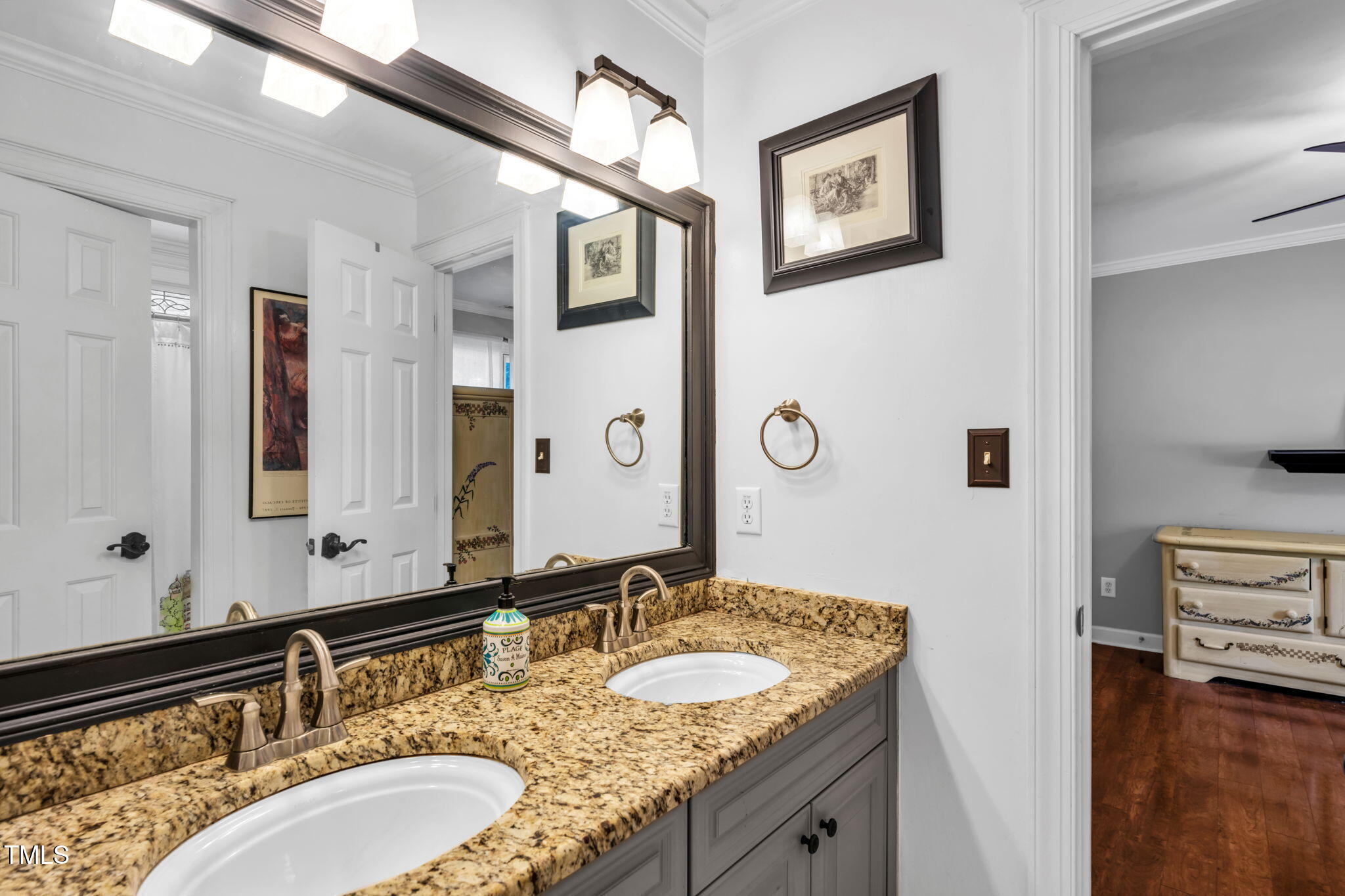 9009 Hometown Drive Raleigh, NC 27615 - Photo 45 of 82 a bathroom with a granite countertop double vanity sink and a mirror