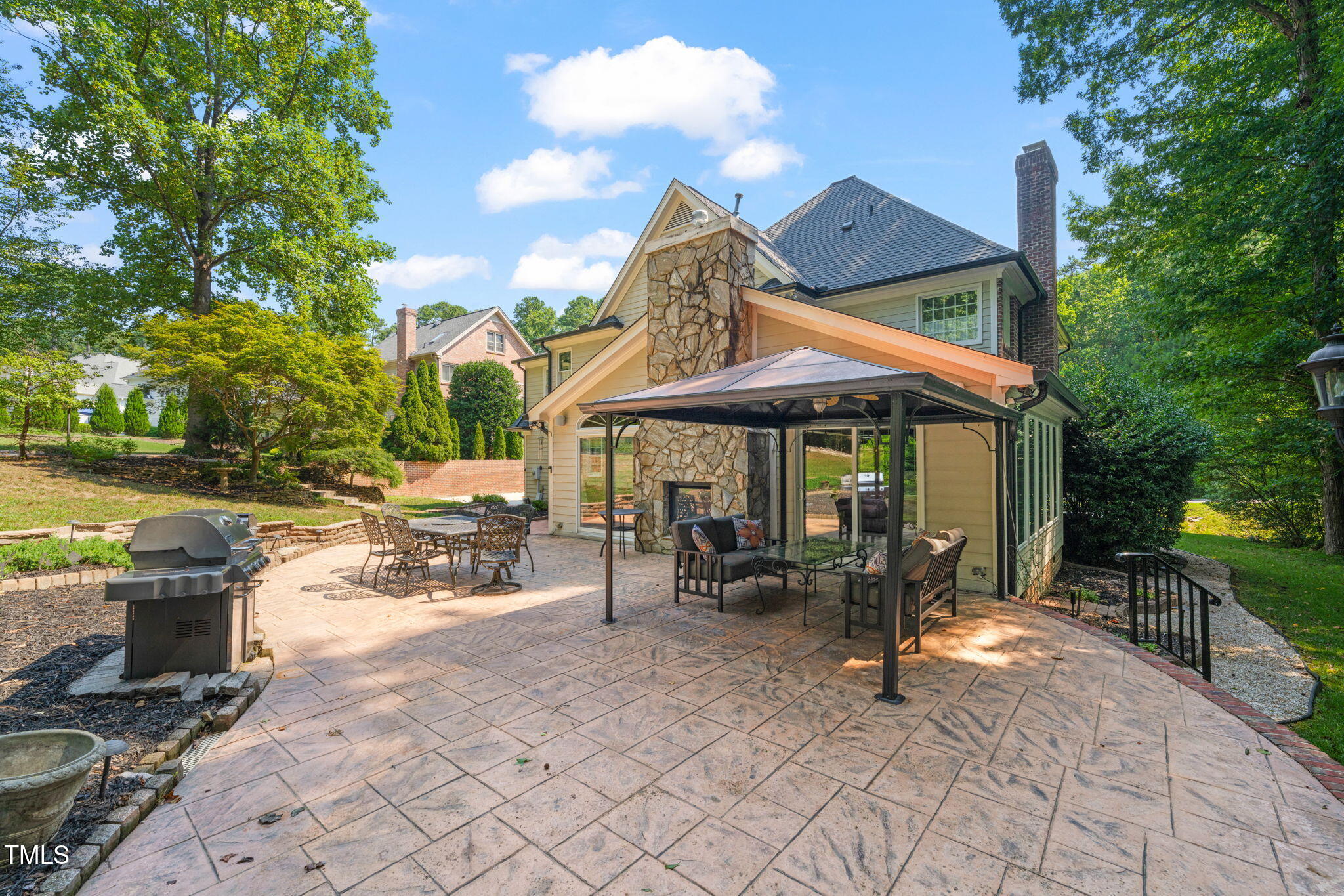 9009 Hometown Drive Raleigh, NC 27615 - Photo 57 of 82 a view of a patio with a table and chairs under an umbrella