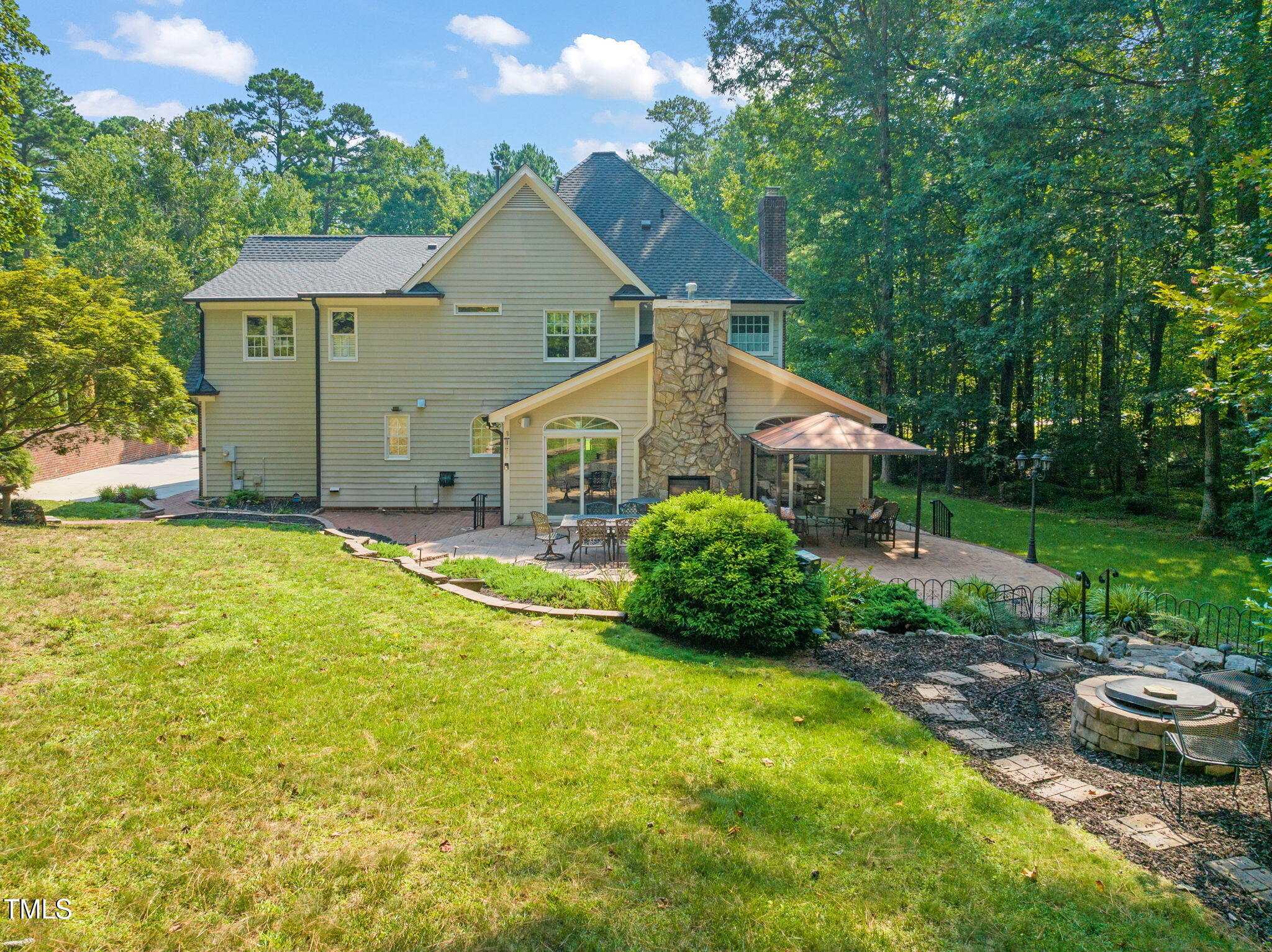 9009 Hometown Drive Raleigh, NC 27615 - Photo 58 of 82 a view of a house with a yard and potted plants