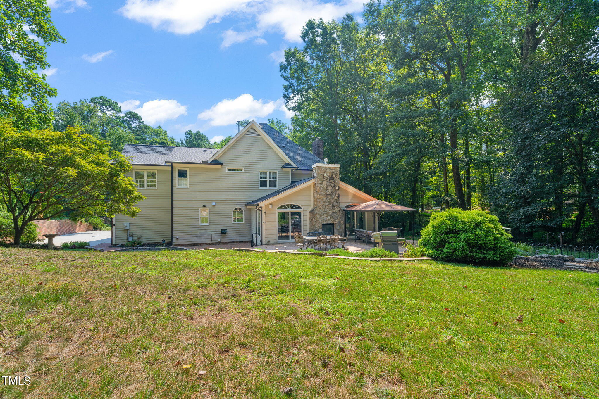 9009 Hometown Drive Raleigh, NC 27615 - Photo 65 of 82 a white house with a big yard and large trees