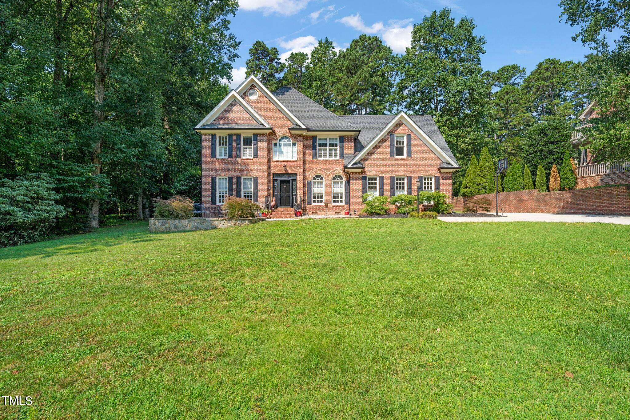 9009 Hometown Drive Raleigh, NC 27615 - Photo 66 of 82 a front view of a house with a yard and trees