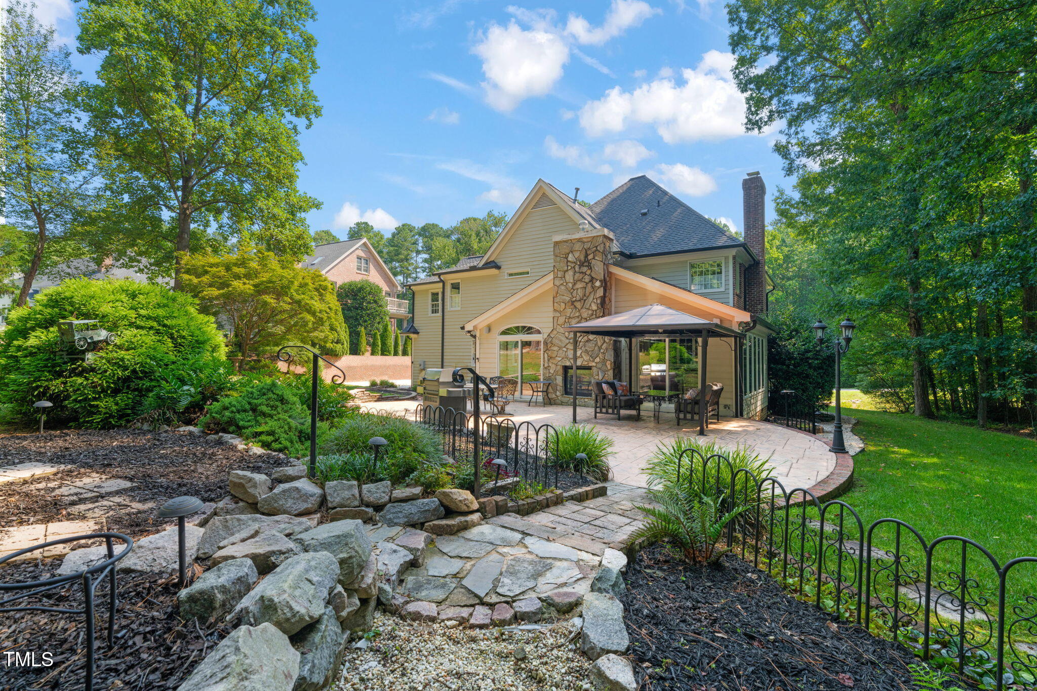 9009 Hometown Drive Raleigh, NC 27615 - Photo 6 of 82 a view of a patio with table and chairs under an umbrella