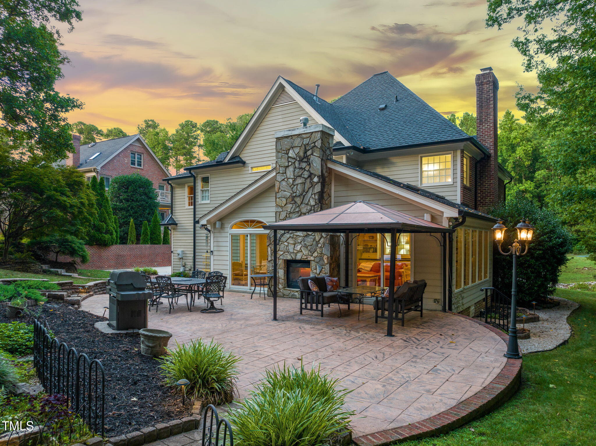 9009 Hometown Drive Raleigh, NC 27615 - Photo 78 of 82 a view of a patio with table and chairs potted plants and a large tree