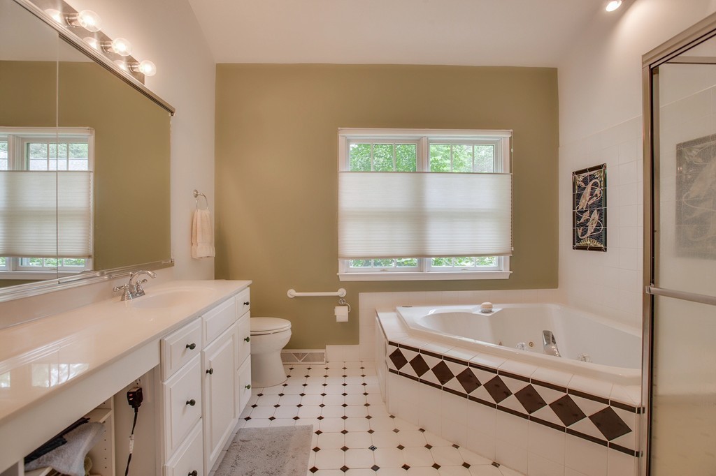 5 Emery Road, Unit 5 Bedford, MA 01730 - Photo 15 of 29 a bathroom with a bathtub a sink a toilet and a window