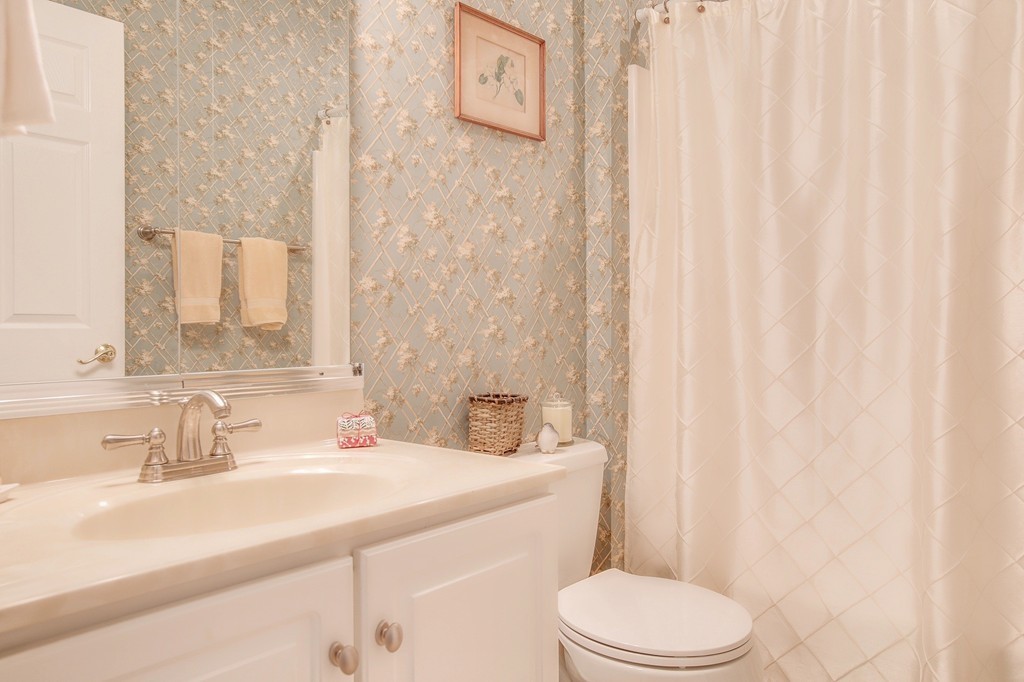 5 Emery Road, Unit 5 Bedford, MA 01730 - Photo 17 of 29 a bathroom with a sink a toilet and shower curtain