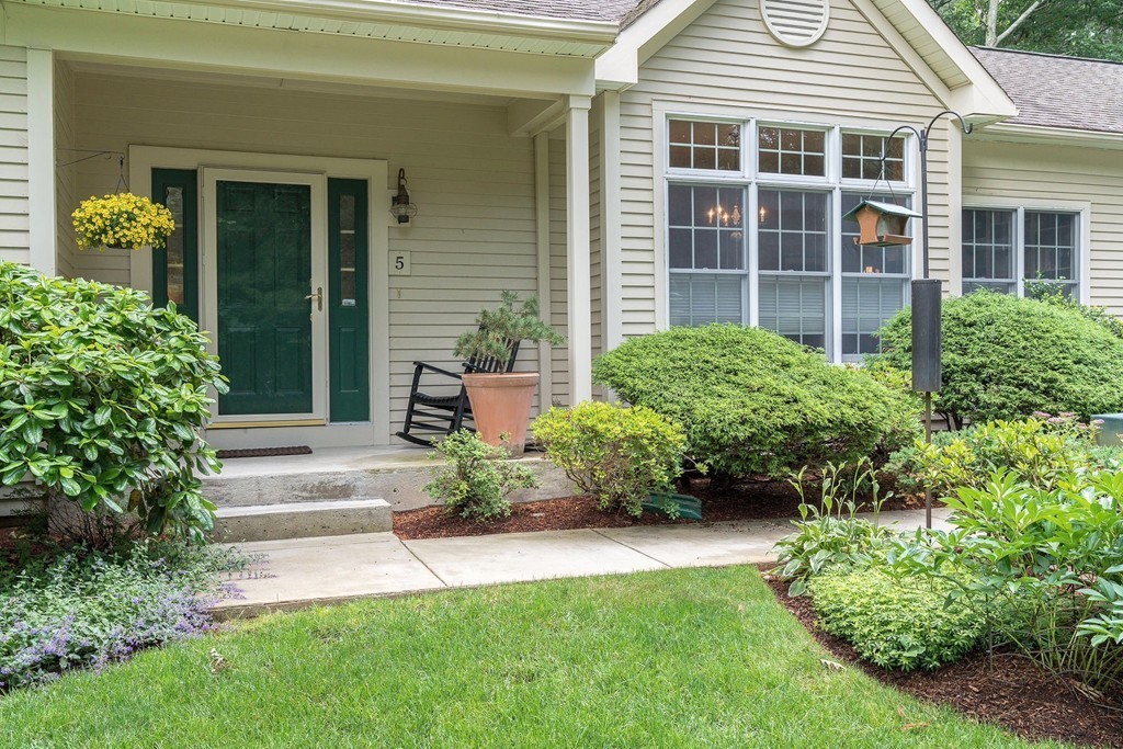 5 Emery Road, Unit 5 Bedford, MA 01730 - Photo 21 of 29 a view of a house with potted plants and a table and chair