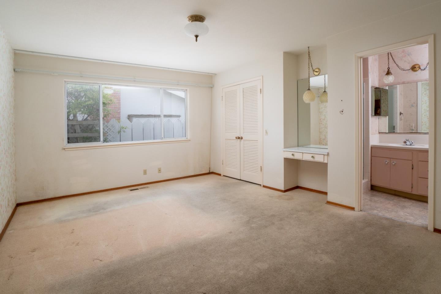 3010 Ribera Road Carmel, CA 93923 - Photo 9 of 16 a view of an empty room with a window and a kitchen