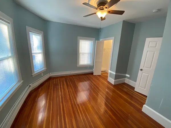 wooden floor in an empty room with a window