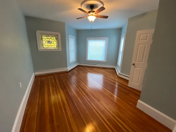 wooden floor in an empty room with a window