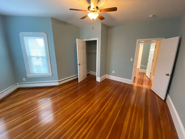 wooden floor in an empty room with a window