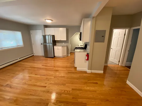 a view of a kitchen with wooden floor