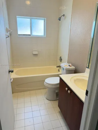 a bathroom with a sink a toilet and a bathtub