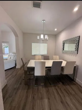 a view of a dining room with furniture and wooden floor