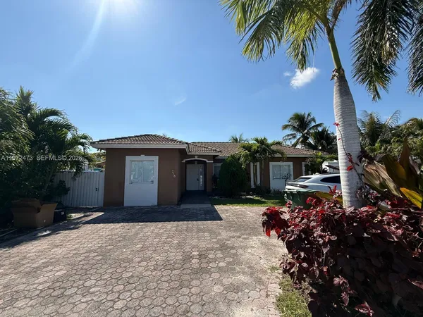 a front view of a house with a yard and a garage