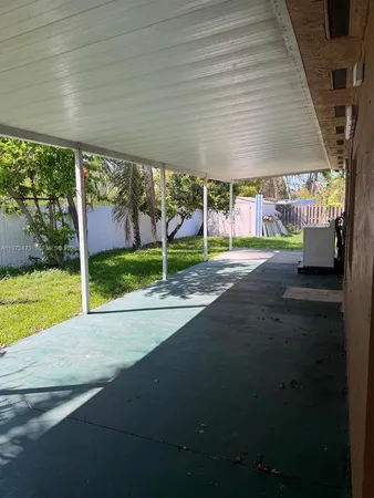 a view of a house with backyard and porch