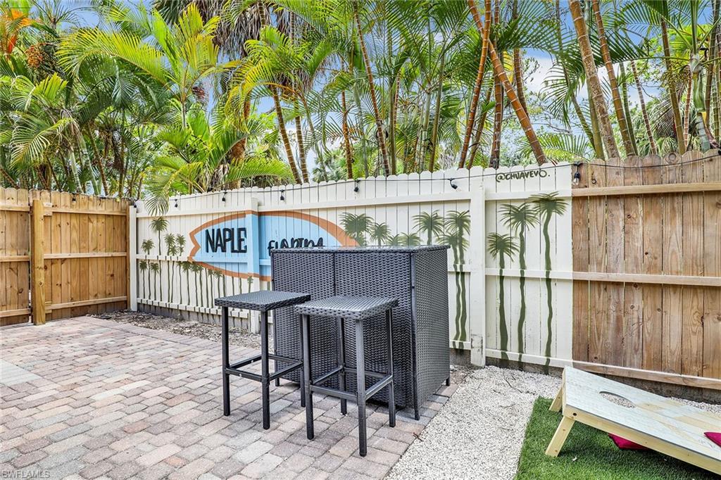 2780 Weeks Avenue Naples, FL 34112 - Photo 16 of 34 a balcony with table and chairs