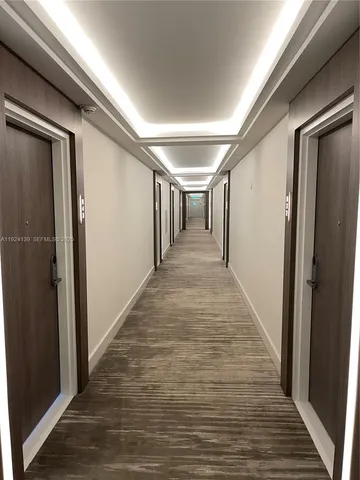 a view of hallway with wooden floor