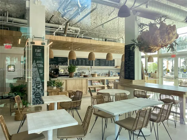 a view of a dining room with furniture large windows and wooden floor
