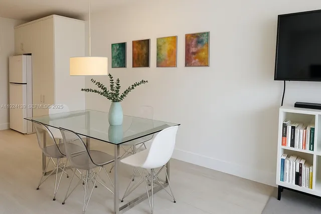 a view of a livingroom with furniture and a flat screen tv