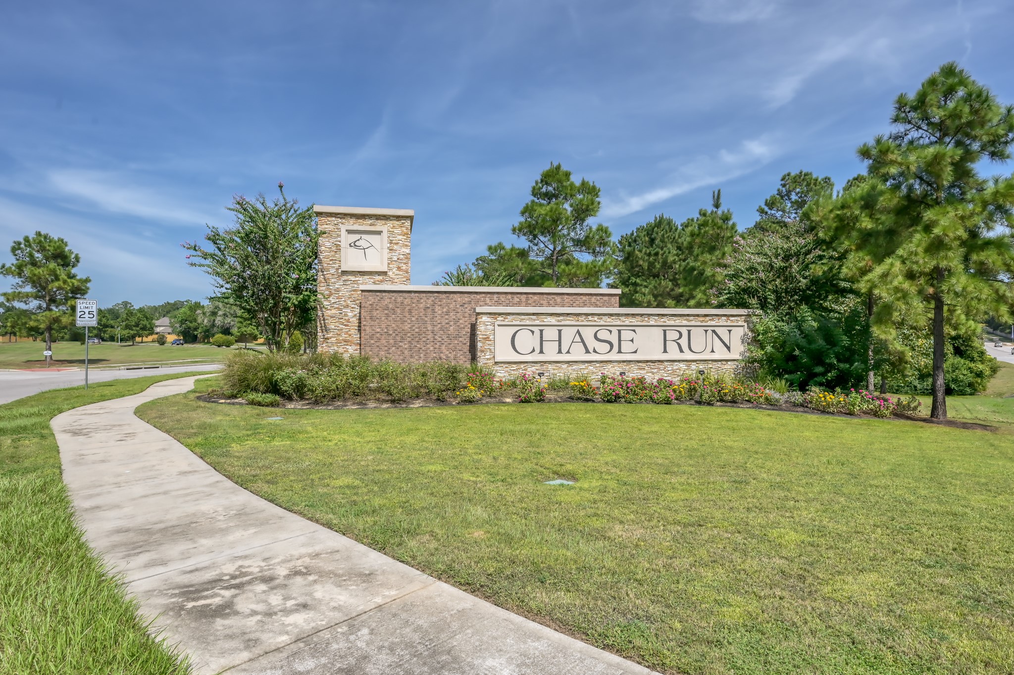7562 Fettle Lane Conroe, TX 77304 - Photo 26 of 30 Welcome to Chase Run — a beautiful community entrance featuring attractive landscaping and a welcoming neighborhood atmosphere.